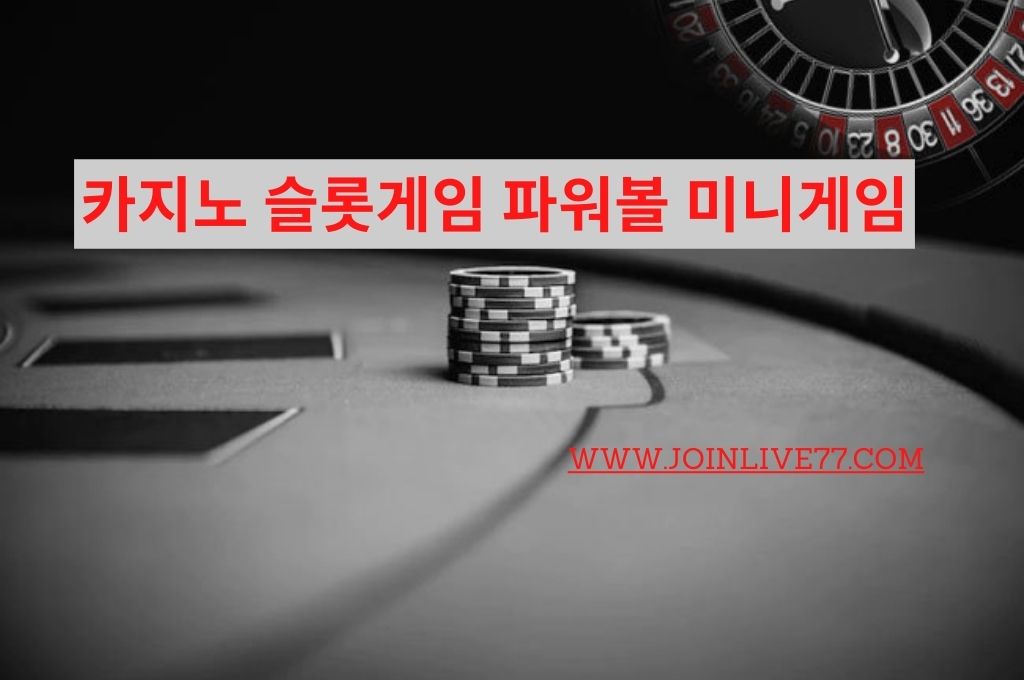 Casino table in a dark room with a chips on it and at the back side is roulette wheel